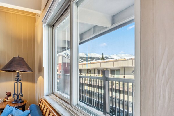 A room with a large window overlooking a train and mountains. - Ski & Racquet Club Condo, Top Floor with Easy Access to Slopes and Downtown (Breckenridge)
