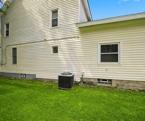 A two-story house with a lawn and an air conditioning unit. - 33 W. Washington - Large Village Home with Room for the Whole Family! (Ellicottville)