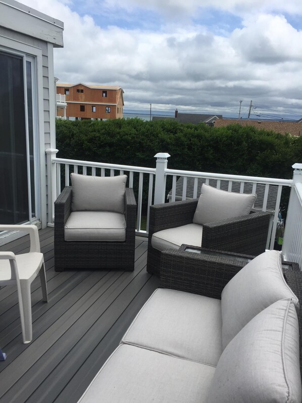 Relax on the covered deck with comfortable lounge chairs and take in the views of the surrounding neighborhood.