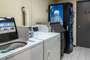 Convenient laundry facilities offer a washing machine, dryer, and water dispenser.