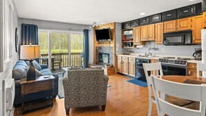 A modern kitchen with wooden cabinets, a built-in microwave, and a gas stove. - 'Escape Plan'  great location for year round fun (Mancelona)