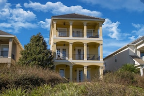 A multi-story building with balconies and a flat roof. - Reunion Disney Villa, Luxury Villa in a gated community, minutes away from WDW. (Reunion)