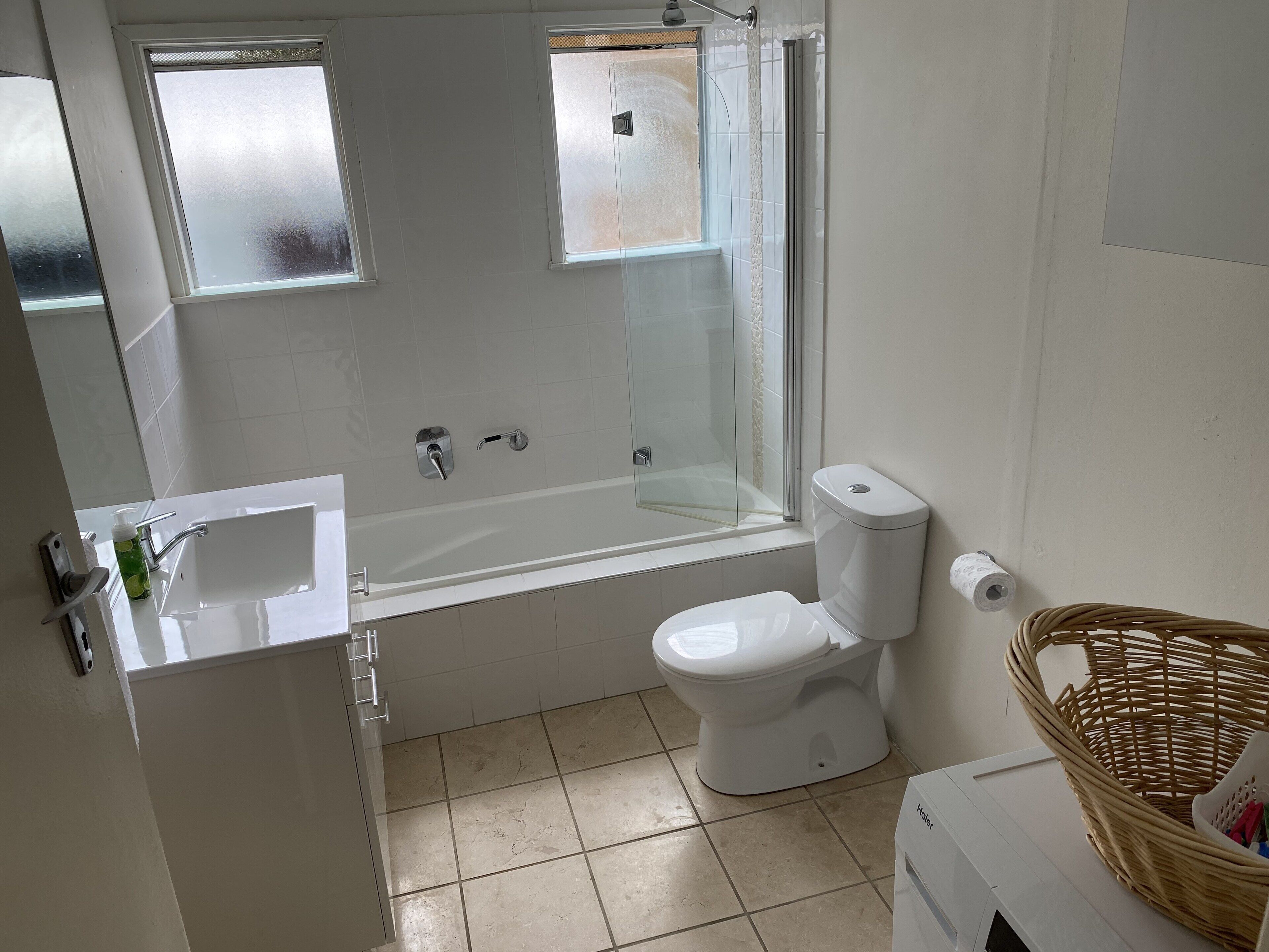 A bathroom with a bathtub, toilet, and sink.