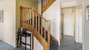 A wooden staircase with a dark wooden table beside it. - Waterside View - A family-friendly retreat - Waterside View - family-friendly retreat with stunning Blackwood River views (Augusta)