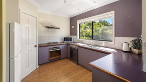 A kitchen with a built-in microwave, stove, oven, and dishwasher. - Waterside View - A family-friendly retreat - Waterside View - family-friendly retreat with stunning Blackwood River views (Augusta)