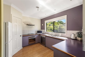 A kitchen with a built-in microwave, stove, oven, and dishwasher.