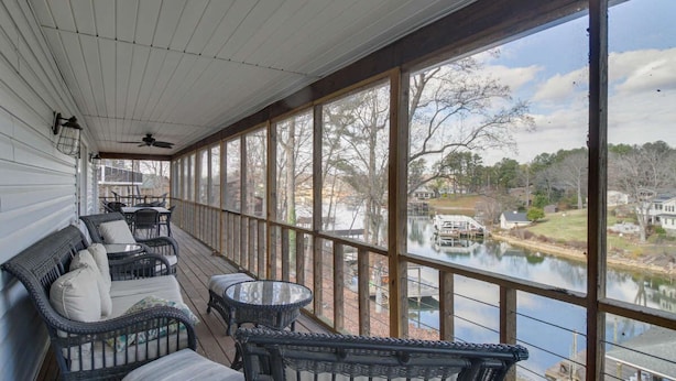 A covered porch with wicker furniture and a view of a lake. - "Sunny Days"-Relaxation for All! Wifi-4 HDTVs-Open/Cov Dock-Game Rm-Linens Incl (Moneta)