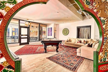 Sun-Filled Gallery Loft Living Room with Large Sofa & Pool Table