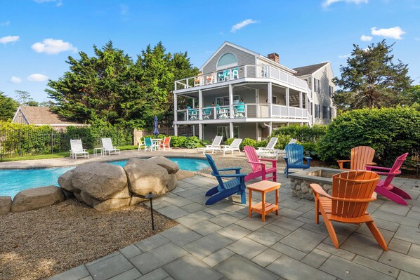 A two-story house with a pool, outdoor seating, and a well-maintained garden. - Water Views Private Pool, Hot Tub, Access to Cove! (West Dennis)