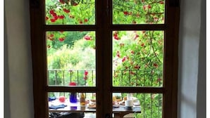 A wooden door with glass panels, leading to an outdoor patio with a table and chairs. - Tuscan Farmhouse in Hills w/Stunning Views - Private Pool, near Barga (Treppignana)