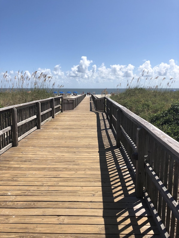 Walk along the oceanfront boardwalk, flanked by railings, and take in the breathtaking views.