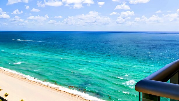 A beach view with turquoise water and a clear sky. - Private Beachfront Condominium with Breathtaking Views and Resort Access (Sunny Isles Beach)