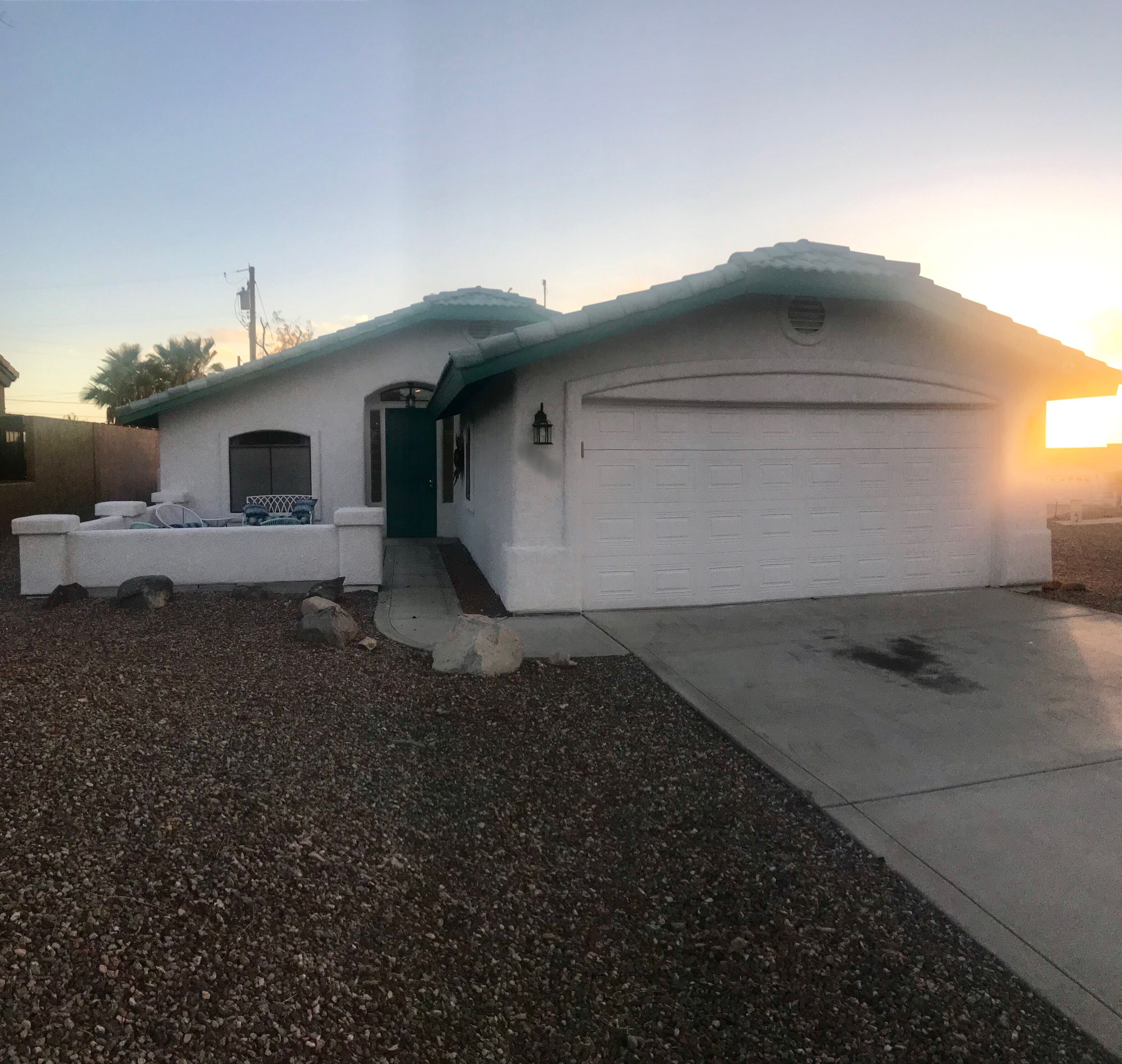 A single-story house with a garage, a front porch, and a driveway.