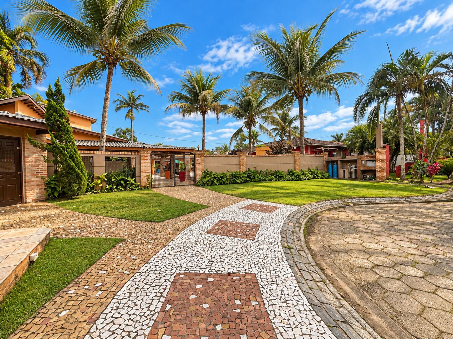 A residential property with a paved walkway, palm trees, and a well-maintained lawn.
