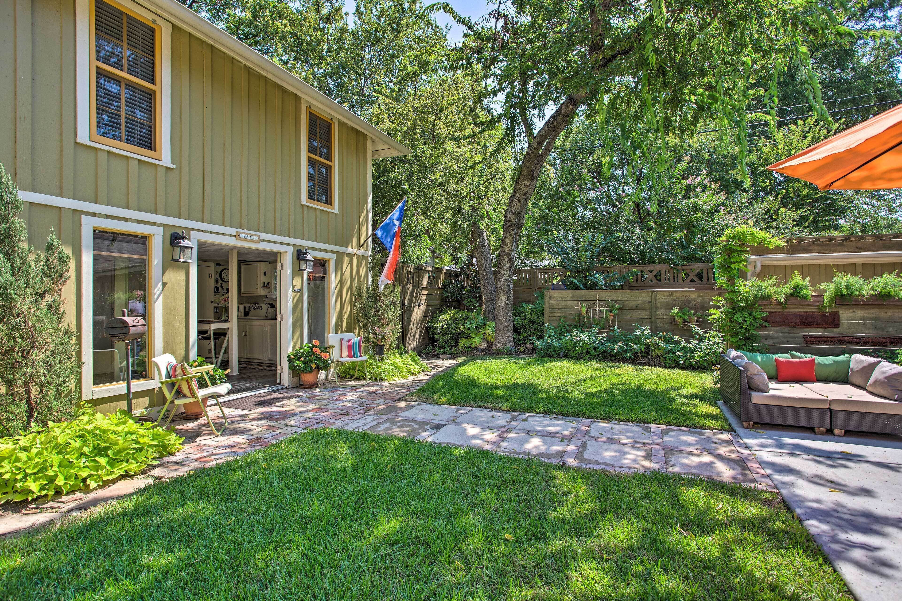 A house with a patio, a lawn, and a flag.