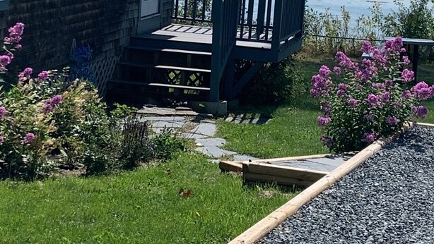A house with a wooden deck and a view of the water. - Ocean Front cottage in Belfast (Belfast)