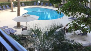 A swimming pool surrounded by palm trees and lounge chairs. - Summer is booking fast! Please book soon. New paint and upgrades!!! (Hilton Head Island)