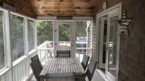 A wooden deck with a table and chairs, a grill, and a sign reading "Chappaquiddick". - Katama House w/Guest House w/AC South Beach heated pool. 
Summer weeks avail. 
 (Edgartown)
