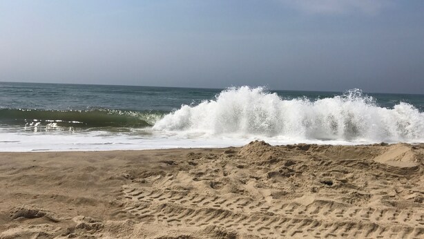 A beach with waves crashing onto the shore, sandy terrain, and footprints in the sand. - Katama House w/Guest House w/AC South Beach heated pool. 
Summer weeks avail. 
 (Edgartown)