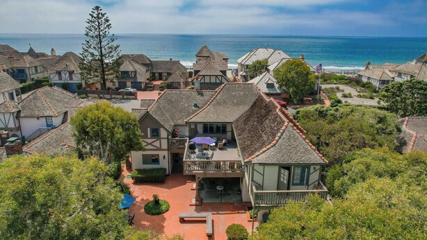 A coastal village with traditional architecture, a central courtyard, and a view of the sea. - Gated Fairytale Estate | Lakefront w/ Ocean Views (Oceanside)