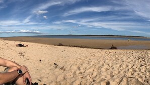 A wide sandy beach with a calm sea and a clear sky. - CHA CHA - Pet Friendly-Netflix WiFi  (Inverloch)