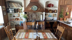 A cozy dining area with a wooden table, chairs, and a patterned table runner. - Private Beach And  Mountain Lake Home (Washington)