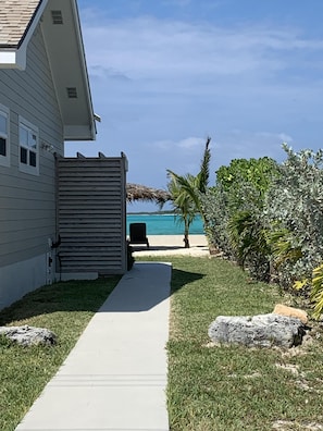 Enjoy a serene beachside retreat with a pathway leading to the shore.