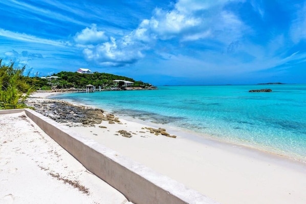 Enjoy a secluded beach experience with turquoise waters and a white sandy shore.