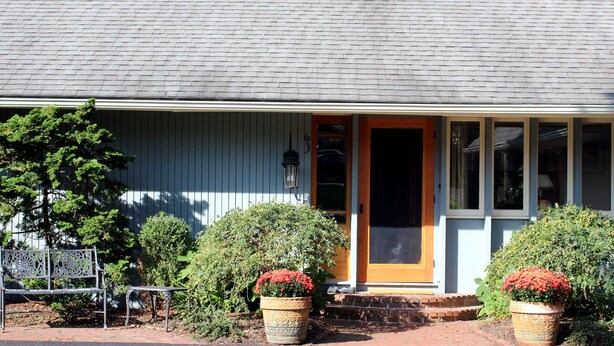 A house with a front porch, a bench, and two potted plants. - Private En Suite Large Master Bedroom With King Sized Bed   (Burlington)