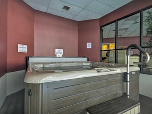 Relax in our spa area, featuring a hot tub with a control panel and faucet.