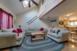 Relax in this inviting living room with a sofa, coffee table, and dining area.