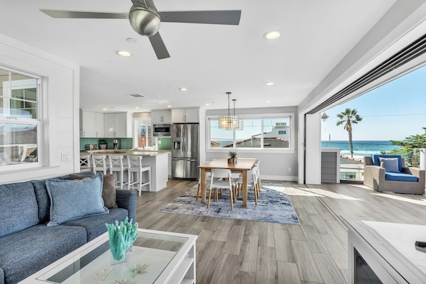 Beautiful open floor plan with abundant natural light, seamlessly connecting the living, dining, and kitchen areas for relaxed coastal living.