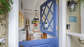 A blue door with a diamond pattern, a hanging lantern, and a sign reading "Seaside Retreat". - Seaside Cottage - Romantic Haven by the Beach (Montecito)