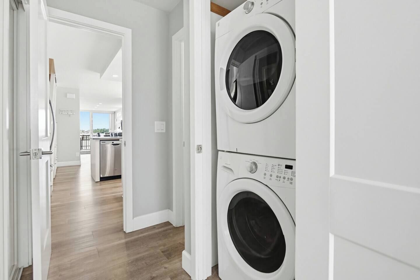 A laundry room with two stacked front-loading washing machines.