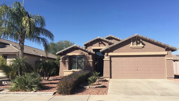 A residential house with a garage, a small attached structure, and a palm tree. - Desert Escape Vacation Rental (Chandler)