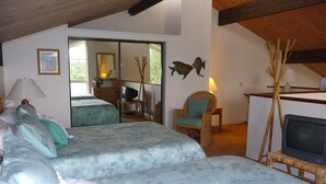A bedroom with two beds, a television, and a chair. - Prime Oceanfront End Unit--View--Family-friendly Cliffs Resort at Bargain Rates (Princeville)