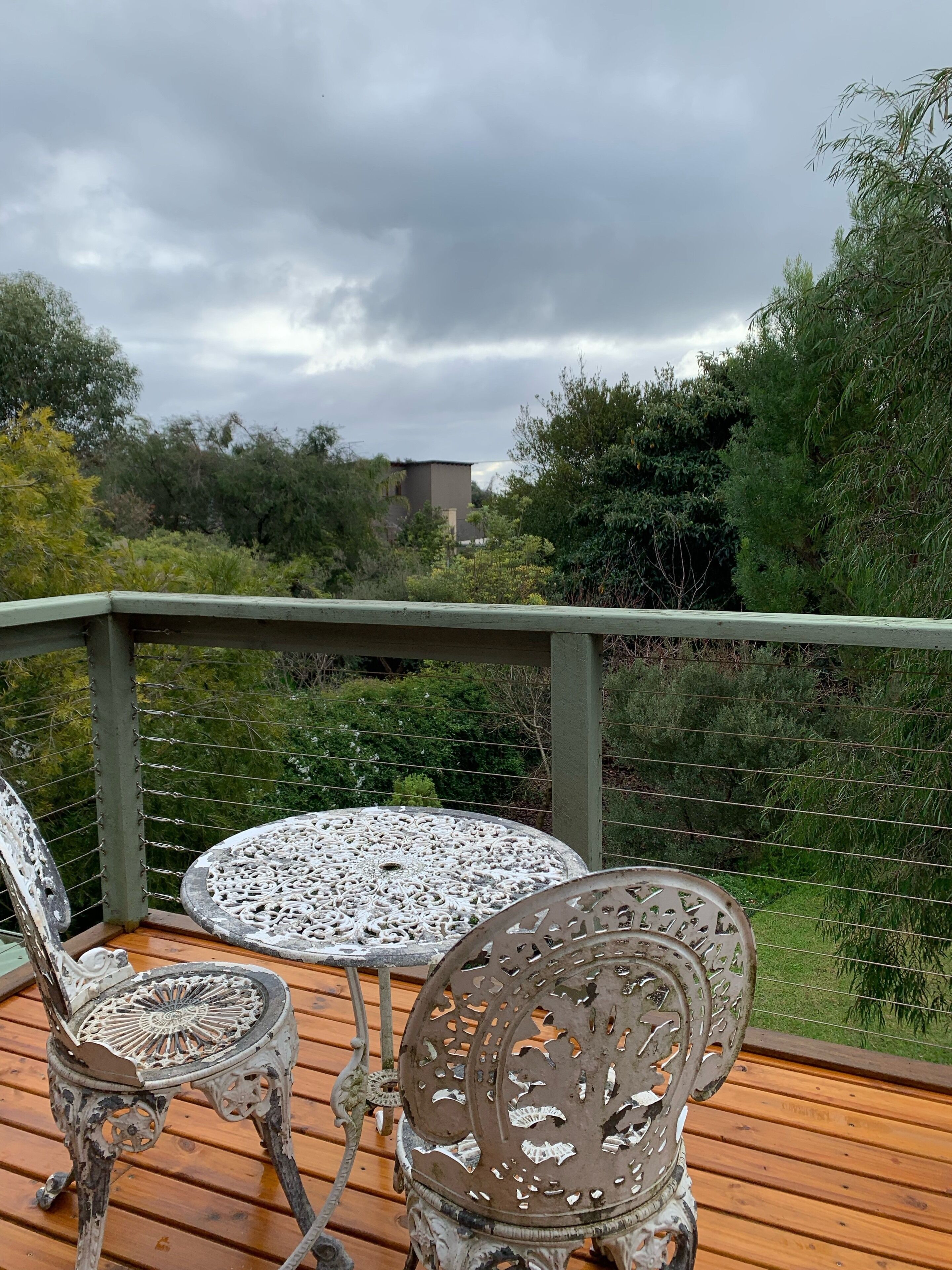 View from balcony overlooking the green backyard- a great spot to watch sunsets