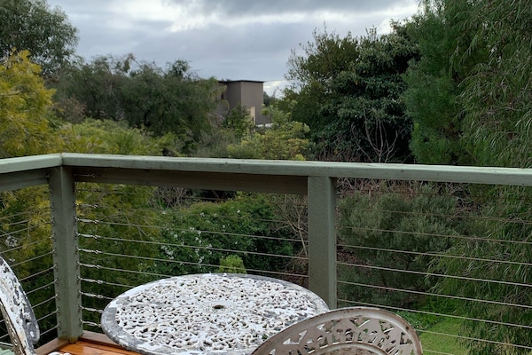View from balcony overlooking the green backyard- a great spot to watch sunsets