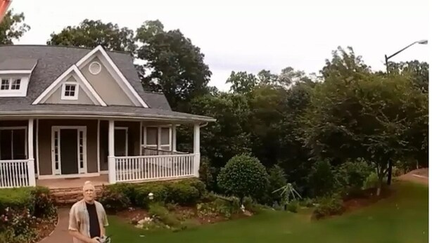 A house with a porch, a lawn, and trees. -  Savannah Suite  (Kennesaw)
