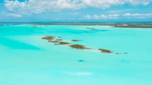 An aerial view of a turquoise sea with several small islands. - Tree House Atmosphere on Chalk Sound National Park (Providenciales)