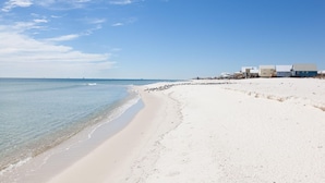 A beach with a row of buildings along the shore. - Best Value Modern family friendly gulfront home (Gulf Shores)