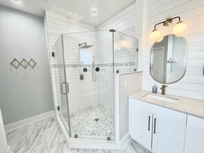 Bathtub, hair dryer, towels, toilet paper