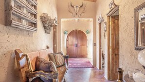 A rustic interior with a wooden bench, a wooden door, and a wall-mounted skull. - Zion Villa/True North:Actually Located in & Surrounded by ZionNP Secluded10Acres (Virgin)
