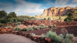A landscaped garden with a wooden fence, rocks, and desert plants. - Zion Villa/True North:Actually Located in & Surrounded by ZionNP Secluded10Acres (Virgin)