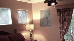 A bedroom with a large bed, a ceiling fan, and two windows with blinds. - WALK to Lake Michigan AND Saugatuck ~ Includes Bicycles! (Douglas)