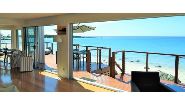 A spacious balcony with a view of the sea, furnished with chairs and a table. - Seventeen Steps To The Beach (Boat Harbour Beach)