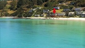 A coastal property with a beach view, houses, and a red arrow pointing to a specific location. - Seventeen Steps To The Beach (Boat Harbour Beach)