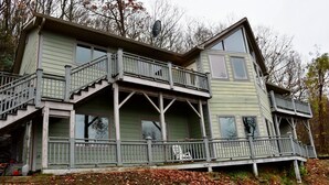 A two-story house with a balcony, a staircase, and a satellite dish.