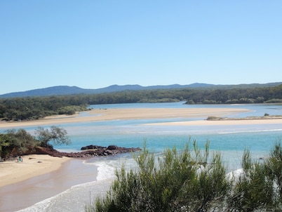Old style beach house with views of the river joining the ocean