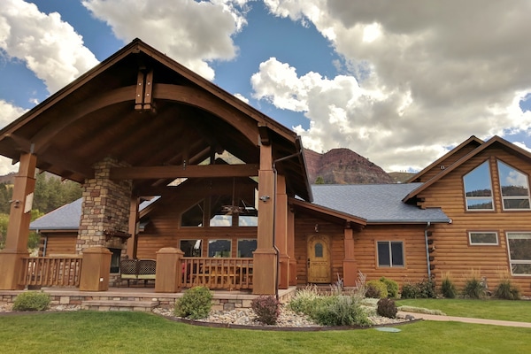 Massive outdoor living porch has woodburning fireplace, sitting area, 14' table.